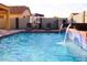 Refreshing pool with water feature, basketball hoop, and comfortable seating at 43542 W Caven Dr, Maricopa, AZ 85138