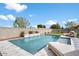 Modern rectangular pool with a waterfall feature at 1132 W Pagoda Ave, Queen Creek, AZ 85140