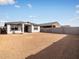 View of the home's backyard with dirt and concrete perimeter walls at 16017 W Cottontail Ln, Surprise, AZ 85387