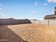 Empty backyard with dirt and concrete perimeter walls at 16017 W Cottontail Ln, Surprise, AZ 85387