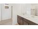 Bright bathroom featuring a double sink vanity and walk-in shower at 16017 W Cottontail Ln, Surprise, AZ 85387