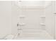 A full tub and shower with shelves and silver fixtures at 16017 W Cottontail Ln, Surprise, AZ 85387