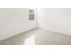 Carpeted bedroom with a window and white walls at 16017 W Cottontail Ln, Surprise, AZ 85387