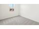 A bright bedroom with carpeted floors and view to exterior at 16017 W Cottontail Ln, Surprise, AZ 85387
