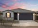 A beautifully staged single-story home with a clean desert landscape and neutral palette at 16017 W Cottontail Ln, Surprise, AZ 85387