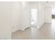 Bright hallway featuring stylish wood-look tile flooring and neutral paint at 16017 W Cottontail Ln, Surprise, AZ 85387