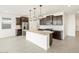 Modern kitchen features pendant lighting, stainless steel appliances, and a kitchen island at 16017 W Cottontail Ln, Surprise, AZ 85387