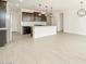 Bright kitchen with a large island, stainless steel appliances, and wood-look tile flooring at 16017 W Cottontail Ln, Surprise, AZ 85387