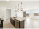 Open-concept kitchen with a large island, stainless steel appliances, and seamless transition to the living area at 16017 W Cottontail Ln, Surprise, AZ 85387
