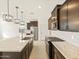 Spacious kitchen featuring a large island with seating, stainless steel appliances, and stylish lighting at 16017 W Cottontail Ln, Surprise, AZ 85387