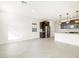 Open-concept living and kitchen area with wood-look tile floors and stainless steel appliances at 16017 W Cottontail Ln, Surprise, AZ 85387