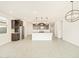 Open-concept living and kitchen area with wood-look tile floors and dark wood cabinets at 16017 W Cottontail Ln, Surprise, AZ 85387
