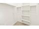 Spacious walk-in closet featuring shelving and closet rod at 16017 W Cottontail Ln, Surprise, AZ 85387