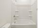 A clean bathroom features a bathtub with white tile surround and chrome fixtures at 16035 W Desert Hollow Dr, Surprise, AZ 85387