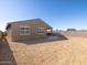 Large, blank canvas backyard with block wall, ideal for creating your own outdoor oasis and entertainment area at 16082 W Desert Spoon Dr, Surprise, AZ 85387