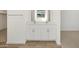 Bathroom featuring double sinks, a mirror, and tile flooring at 16082 W Desert Spoon Dr, Surprise, AZ 85387