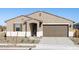 Charming single-story home with a two-car garage and neutral-toned exterior at 16082 W Desert Spoon Dr, Surprise, AZ 85387