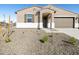 Well-maintained front yard with desert landscaping and a clean, modern design at 16082 W Desert Spoon Dr, Surprise, AZ 85387