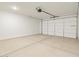 Spacious two-car garage featuring concrete flooring and automatic door opener, perfect for parking and storage at 16082 W Desert Spoon Dr, Surprise, AZ 85387