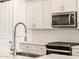 Close-up of the modern kitchen featuring stainless steel appliances and sleek fixtures at 16082 W Desert Spoon Dr, Surprise, AZ 85387