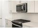Contemporary kitchen details showcasing a microwave and gas range at 16082 W Desert Spoon Dr, Surprise, AZ 85387