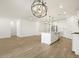 Bright and airy living space showcasing an open floor plan, kitchen with island, and modern light fixtures at 16082 W Desert Spoon Dr, Surprise, AZ 85387