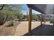 Covered back patio with brick flooring offers scenic desert landscaping with a rock waterfall pool at 2926 W Tanya Trl, Phoenix, AZ 85086