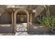Close-up of the inviting front entrance featuring a rustic wooden door and arched entryway at 2926 W Tanya Trl, Phoenix, AZ 85086