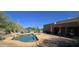 Desert backyard featuring a stunning pool, lush greenery, and a covered patio, perfect for outdoor gatherings at 2926 W Tanya Trl, Phoenix, AZ 85086