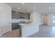 Modern kitchen with gray cabinets, white quartz countertops, and stainless steel appliances at 40000 W Bunker Dr, Maricopa, AZ 85138