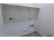 Laundry room with shelving and hookups at 40000 W Bunker Dr, Maricopa, AZ 85138