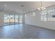 Spacious living room with tile floors and sliding glass doors leading to the backyard at 40000 W Bunker Dr, Maricopa, AZ 85138