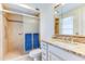 Modern bathroom with a glass-enclosed shower, granite countertop vanity, and bright lighting, blending style and functionality at 9902 W Sandstone Dr, Sun City, AZ 85351