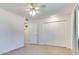Bright bedroom with neutral tones, a ceiling fan, and ample closet space for comfortable living at 9902 W Sandstone Dr, Sun City, AZ 85351