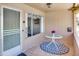 Cozy front porch with a decorative rug and a small table, creating a welcoming entrance and a relaxing outdoor space at 9902 W Sandstone Dr, Sun City, AZ 85351