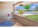 Inviting front porch with a brick facade and decorative table, creating a cozy and welcoming outdoor space at 9902 W Sandstone Dr, Sun City, AZ 85351