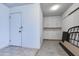 Tidy garage interior featuring built-in storage and convenient access door at 9902 W Sandstone Dr, Sun City, AZ 85351