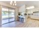 Eat-in kitchen with bar seating and sliding door to backyard patio at 9902 W Sandstone Dr, Sun City, AZ 85351