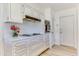 Well-lit kitchen with ample counter space and white cabinets at 9902 W Sandstone Dr, Sun City, AZ 85351
