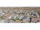 Expansive aerial view of a neighborhood featuring modern homes with varying architectural styles and well-maintained landscaping at 10155 E Toledo Ave, Mesa, AZ 85212