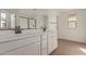 Bathroom featuring double sinks, white cabinetry, and a glass-enclosed shower at 15595 S 181St Dr, Goodyear, AZ 85338