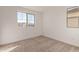 Carpeted bedroom with two windows offering views of the neighborhood at 15595 S 181St Dr, Goodyear, AZ 85338