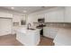 Bright kitchen with white cabinets, stainless steel appliances, island, and stylish backsplash at 15595 S 181St Dr, Goodyear, AZ 85338