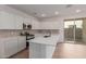 Well-lit kitchen with an island, stainless steel appliances, and sliding glass door at 15595 S 181St Dr, Goodyear, AZ 85338