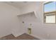 Functional laundry room featuring tile floors, a window, and shelving for storage at 15595 S 181St Dr, Goodyear, AZ 85338