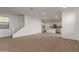 Bright living space featuring wood-look tile floors, staircase, and a seamless transition into the kitchen at 15595 S 181St Dr, Goodyear, AZ 85338