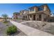 View of modern neighborhood featuring gravel landscaping and sidewalks, providing a clean and contemporary look at 15595 S 181St Dr, Goodyear, AZ 85338