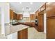 Bright kitchen featuring wood cabinets, tile backsplash, and a large island at 1724 S Rockwell St, Gilbert, AZ 85295