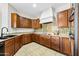 Spacious kitchen with dark wood cabinets, granite counters, and a tile backsplash at 1724 S Rockwell St, Gilbert, AZ 85295