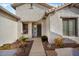 Front entry with walkway, decorative door, and landscaping at 27078 W Yukon Dr, Buckeye, AZ 85396